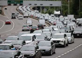 Bank holiday travel chaos: Passengers face train cancellations and HUGE queues as three million drivers hit the road