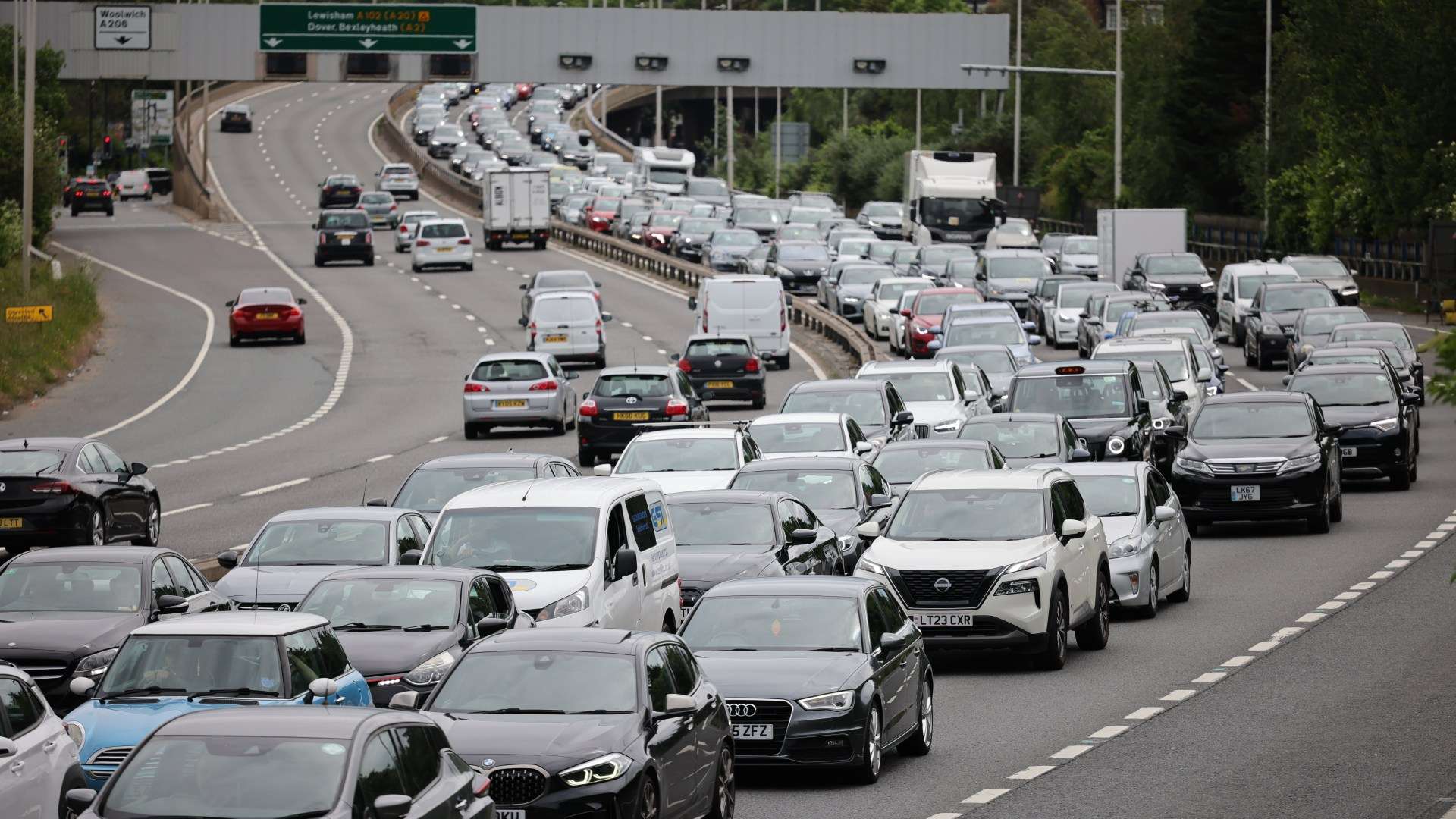 Bank holiday travel chaos: Passengers face train cancellations and HUGE queues as three million drivers hit the road