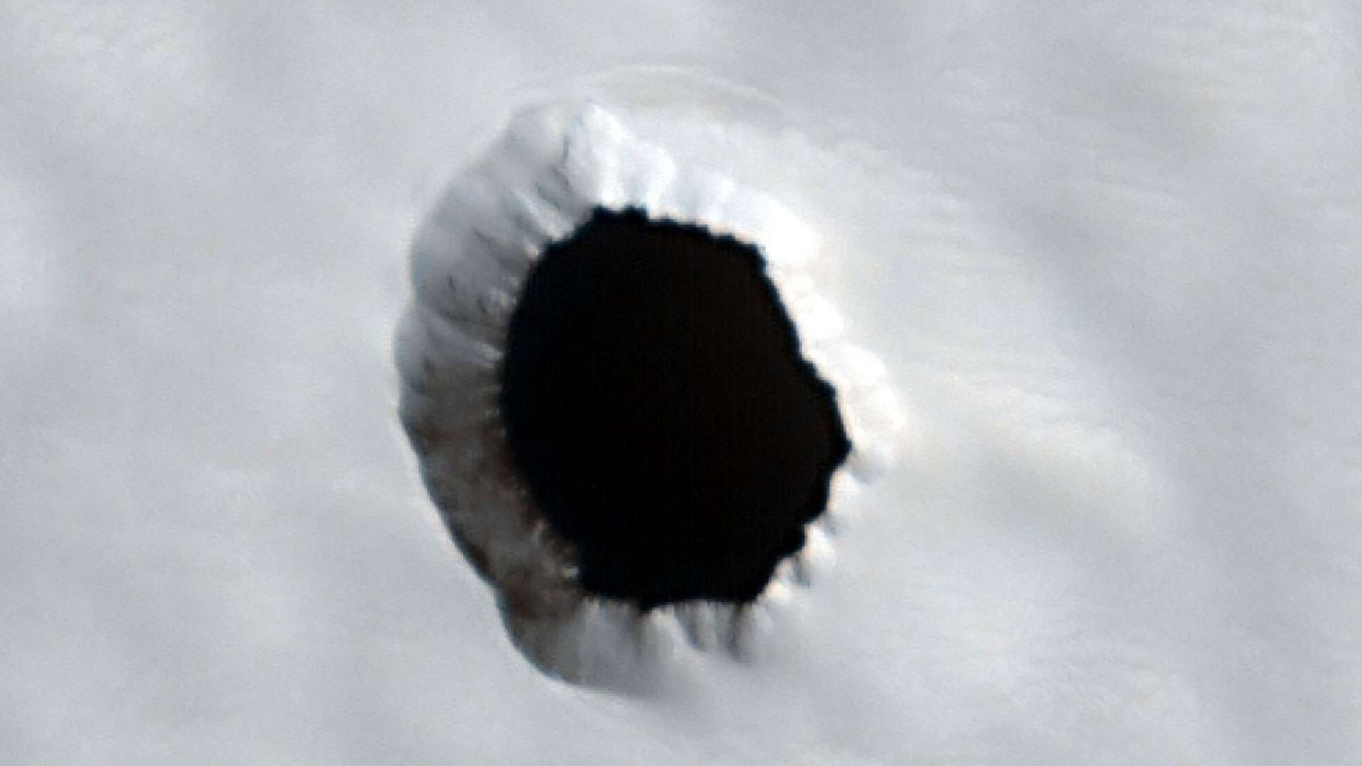 Mystery pitch-black hole 'at least 580ft deep' spotted by Mars probe as scientists share theory on what's hiding inside