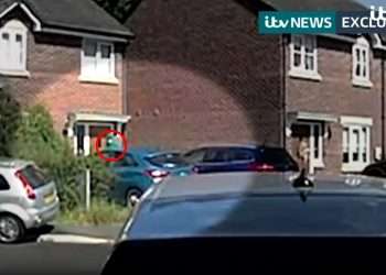 Masked man pictured outside Southport house before it was raided by cops after horror knife attack that left 2 kids dead