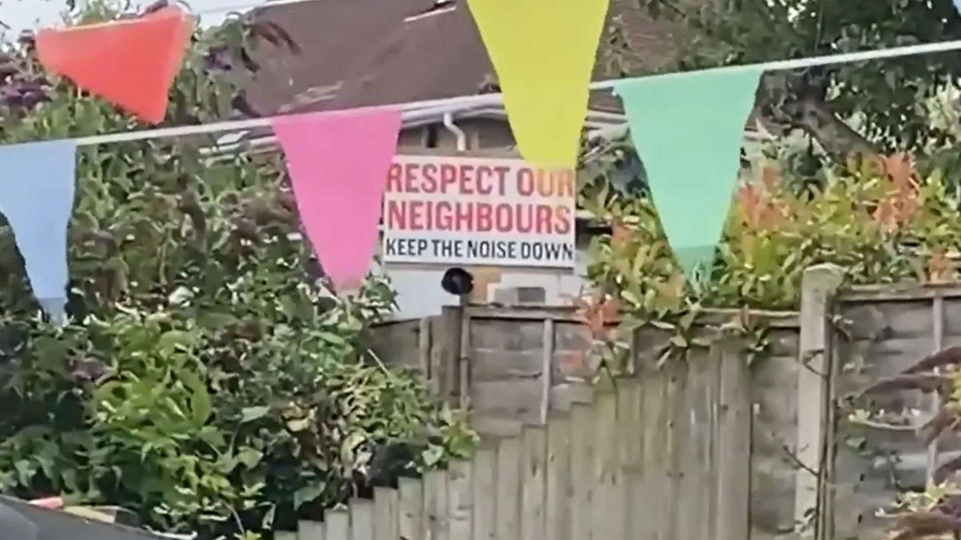 Moment nightmare neighbour blasts FOGHORN to drown out school sports’ day after hanging ‘keep the noise down’ sign